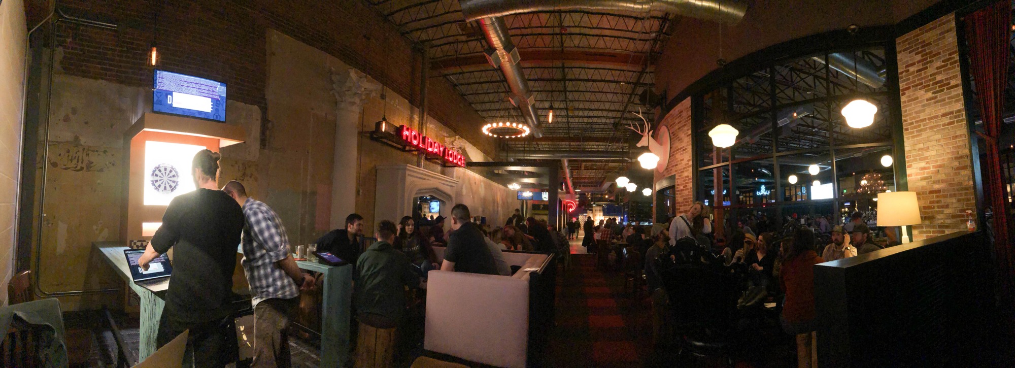 Guests using the Dart Lounge installation inside a Punch Bowl Social venue