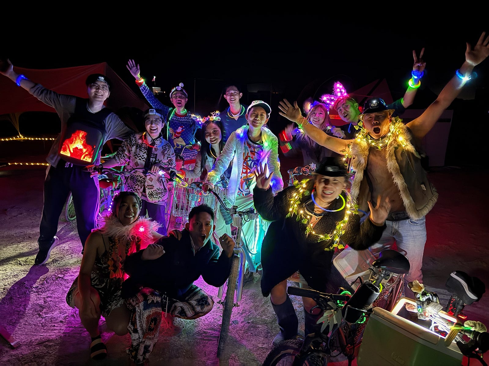 Yiru Yao with friends at night, surrounded by illuminated bicycles and colorful lights