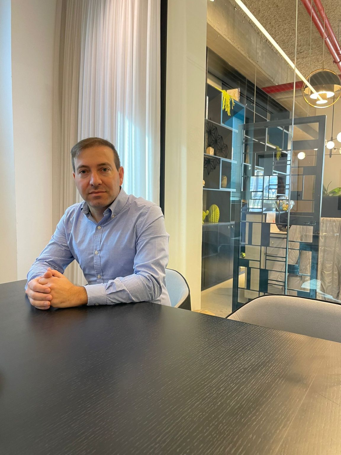 Yisrael Gross seated at a table in the photograph accompanying his Jerusalem office announcement