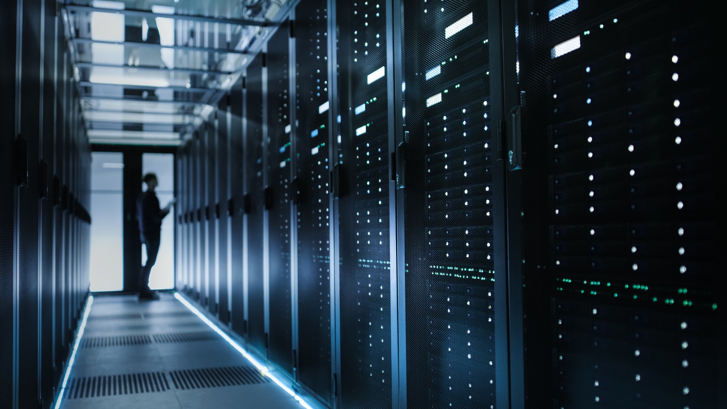 Rows of illuminated server racks in a data centre