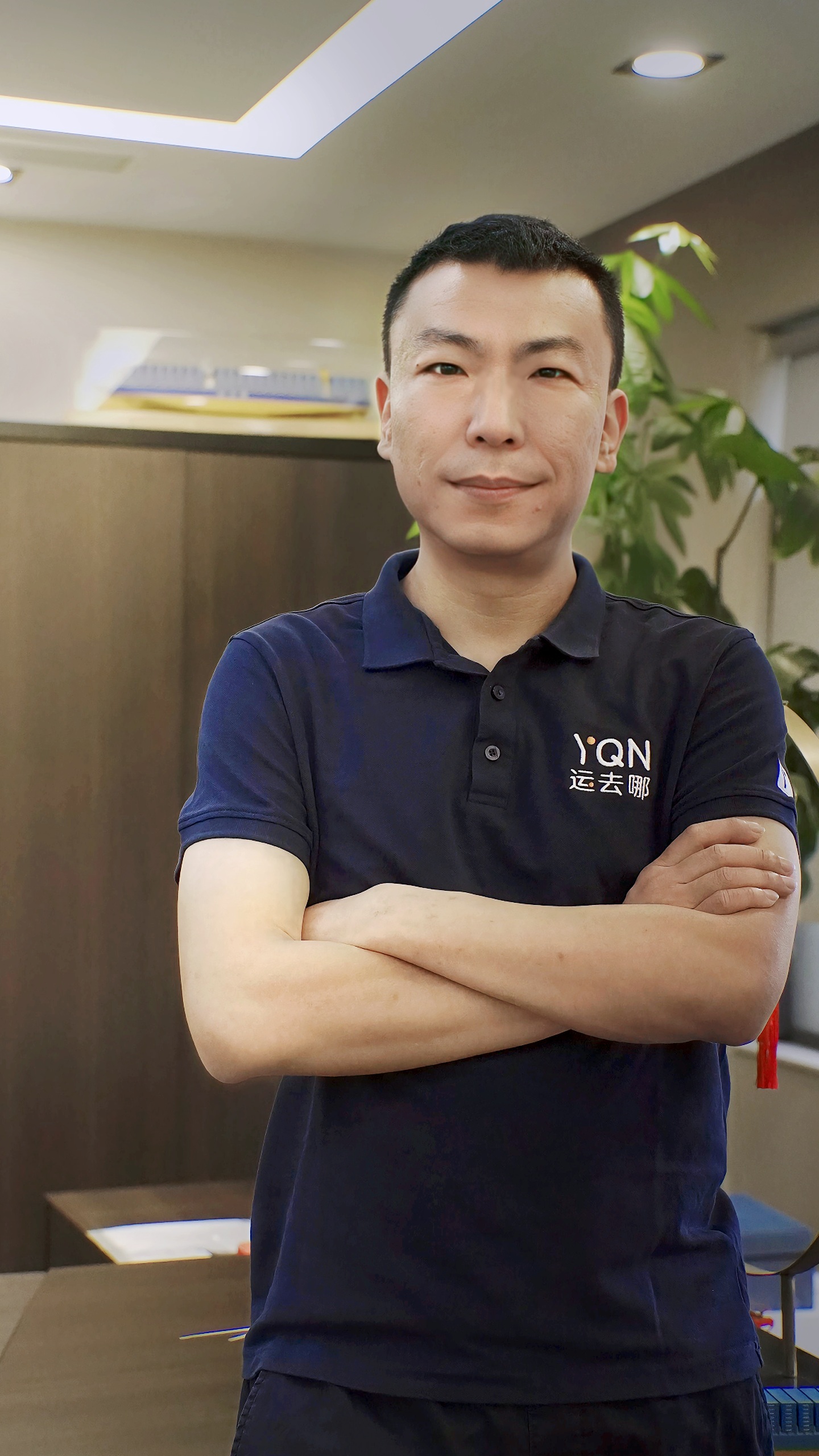 YQN founder and CEO Cash Zhou wearing a YQN polo shirt