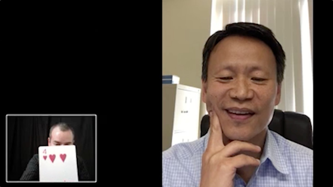 Yuchun Lee smiles during a video interview while James Tehrani holds up a playing card