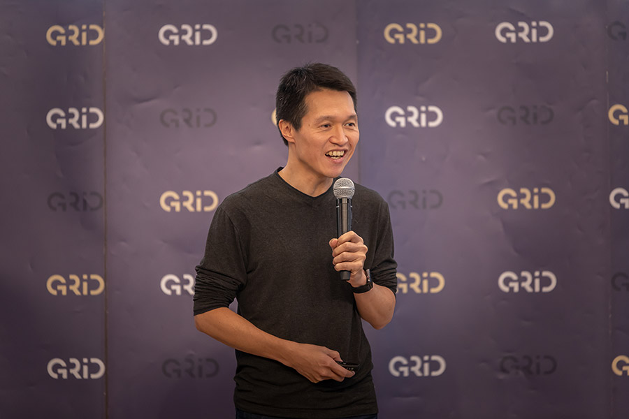 Yuji Ueda speaking into a microphone at a Gaiax staff gathering