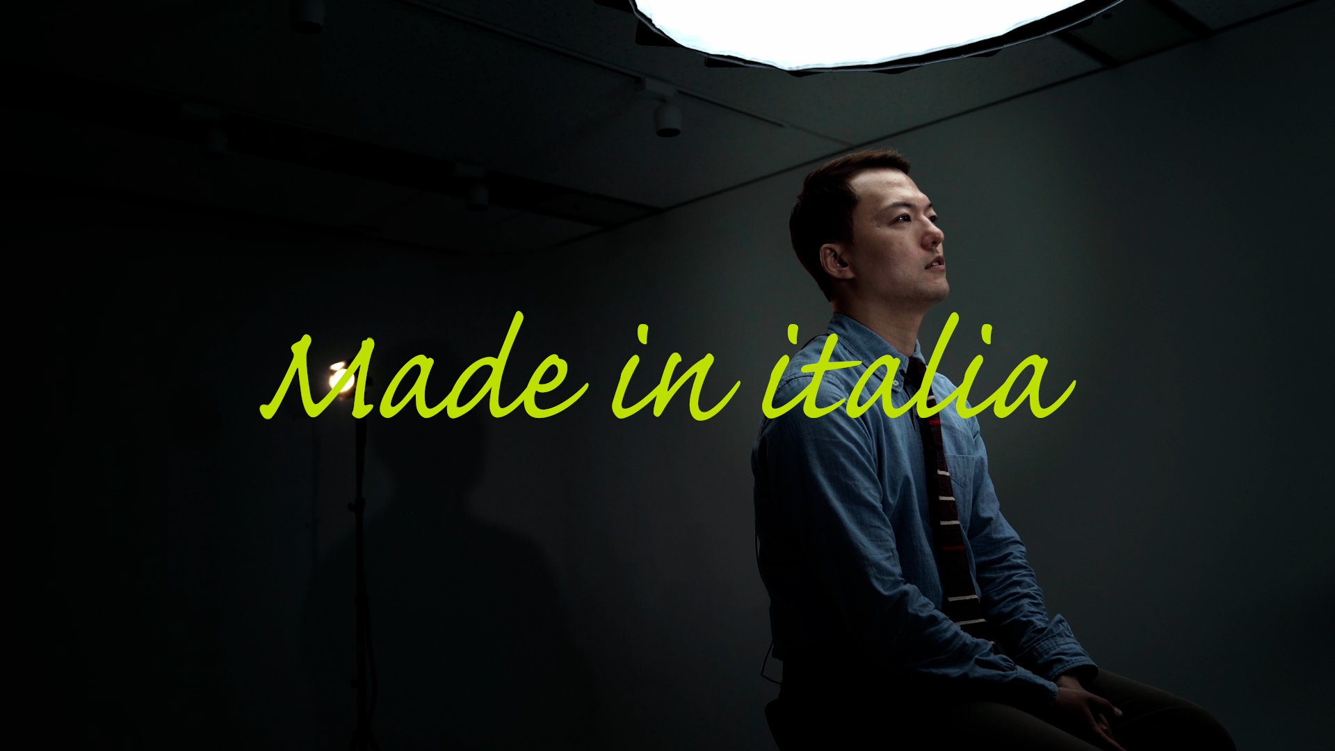 Yulduck Sung seated during a Genuio interview shoot, with Made in Italia lettering across the scene
