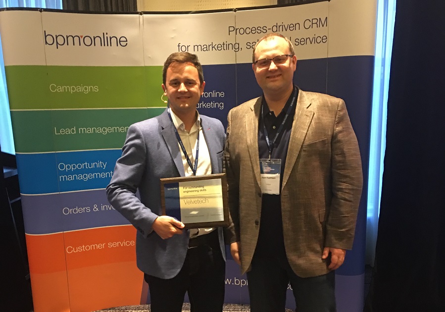 Yuri Yushkov, right, beside Alexander Donchuk holding Velvetech’s engineering award at the 2017 Boston event