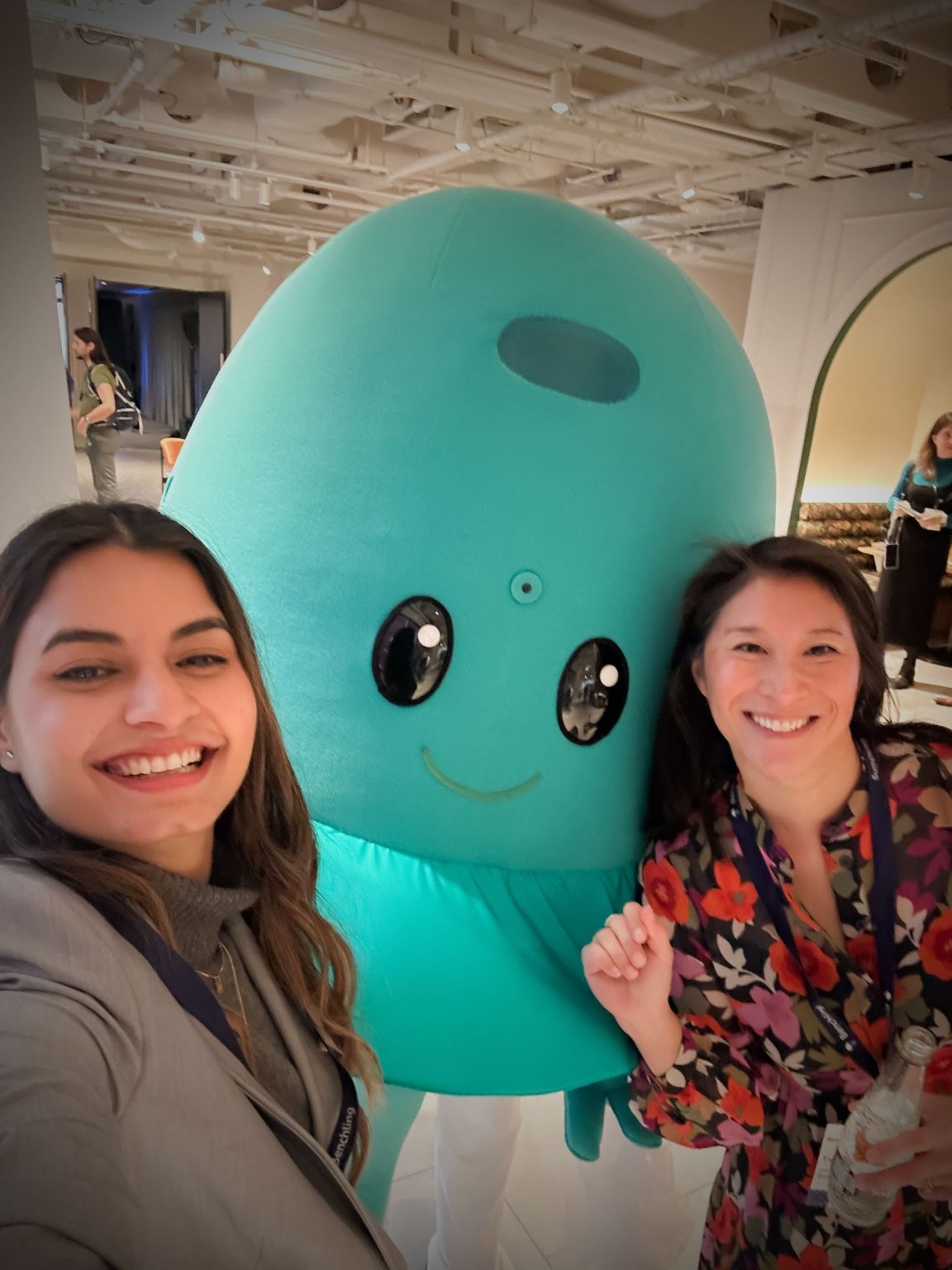 Yvonne Chen and a Benchling colleague posing beside the company's turquoise jellyfish mascot at a Benchling event