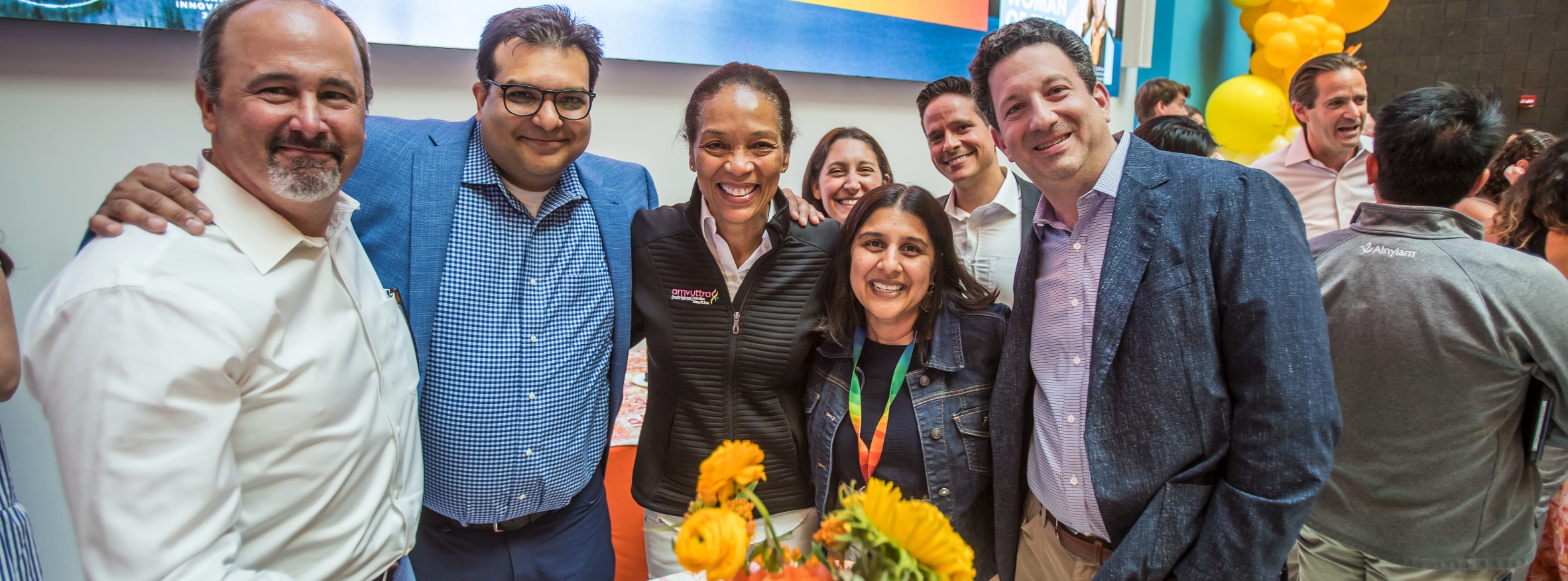 Yvonne Greenstreet smiling with Alnylam colleagues at a company gathering