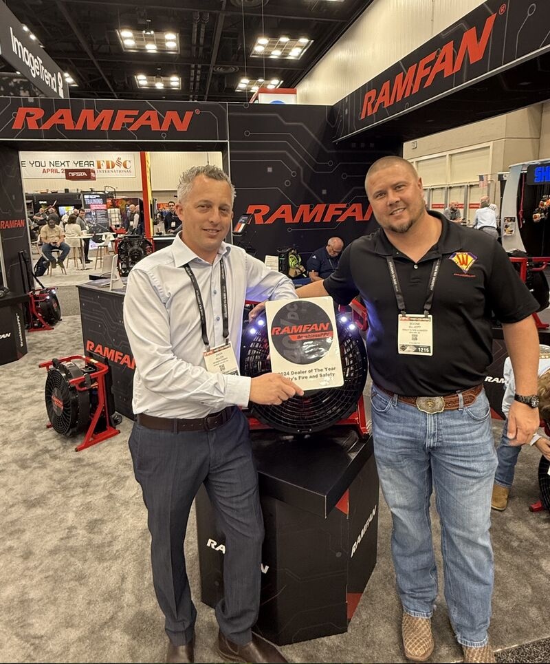 Zach Allen presents a RAMFAN dealer award at FDIC 2025