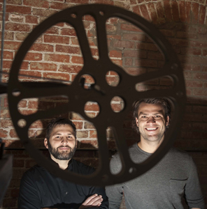 Zefr co-founders Rich Raddon and Zach James standing behind a film reel