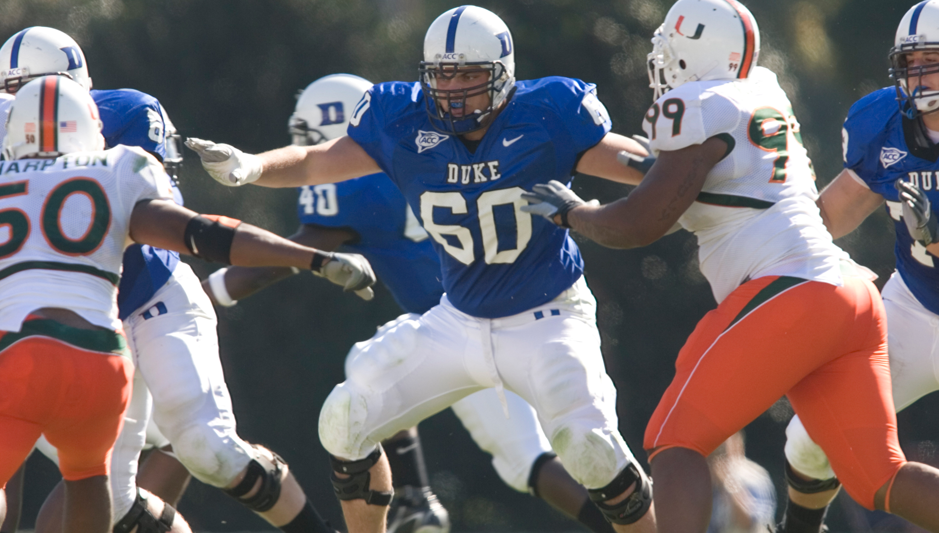 Zach Maurides, wearing Duke number 60, blocking during a football game against Miami