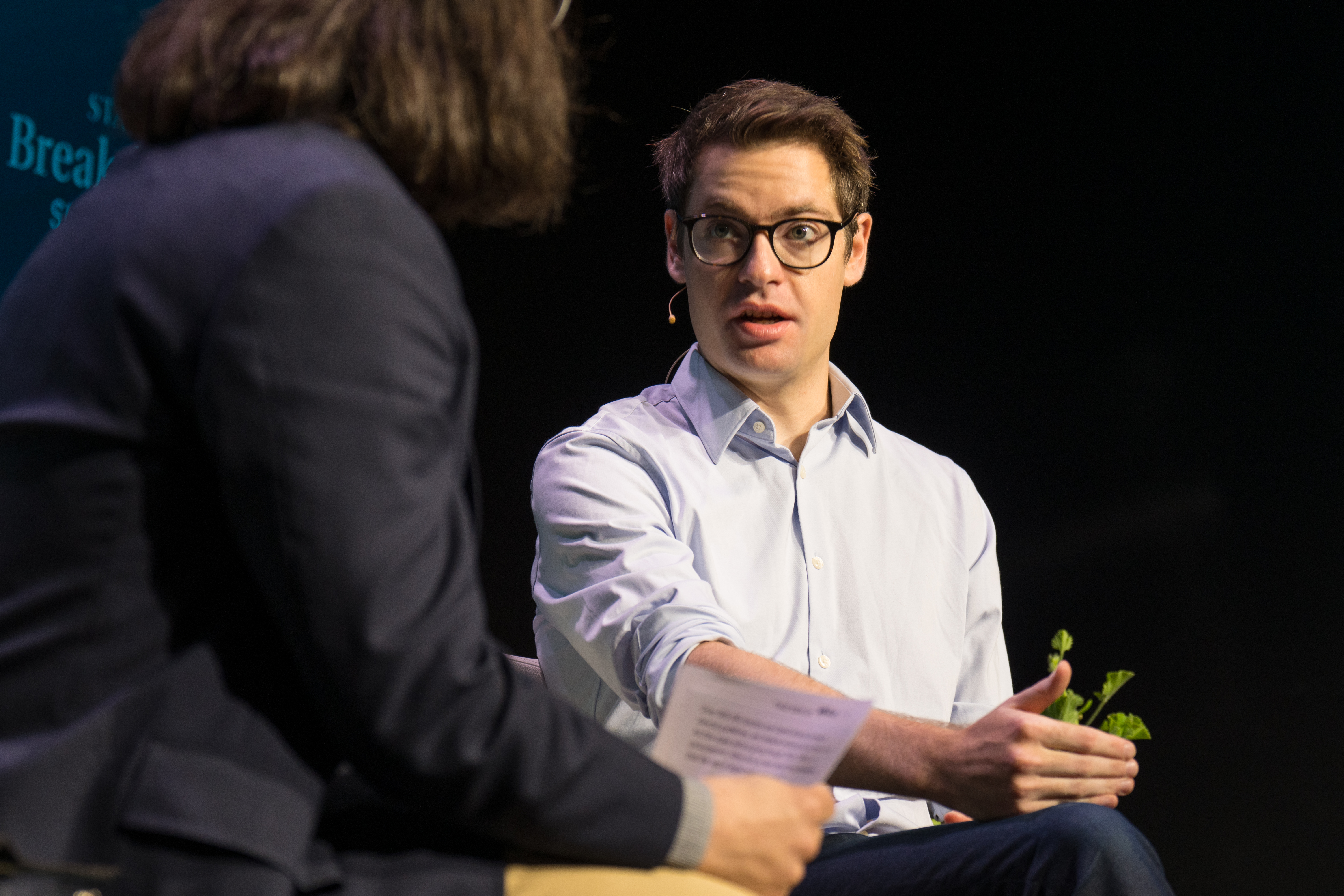 Zachary Ziegler speaking with an interviewer on stage at the STAT Breakthrough Summit West in San Francisco