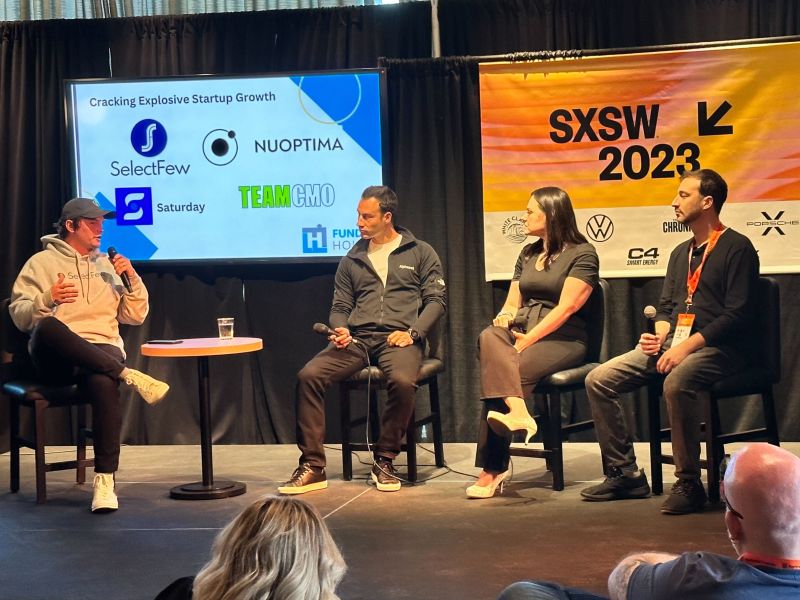 Zack Holland, at left in a SelectFew hoodie, speaking on a startup growth panel at SXSW 2023.