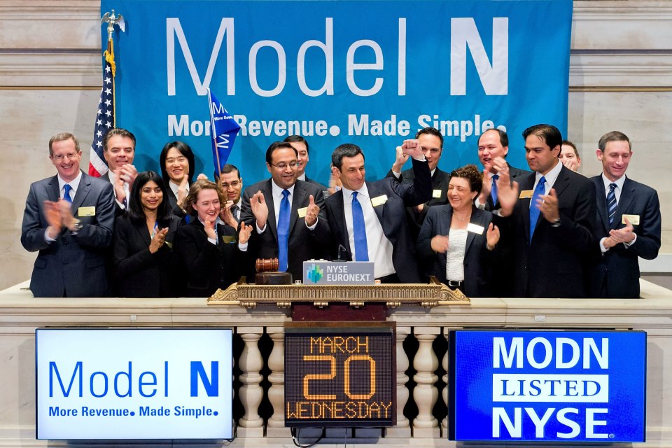Zack Rinat, at the center in a blue tie, celebrates Model N’s 2013 IPO with the team at the NYSE opening bell.