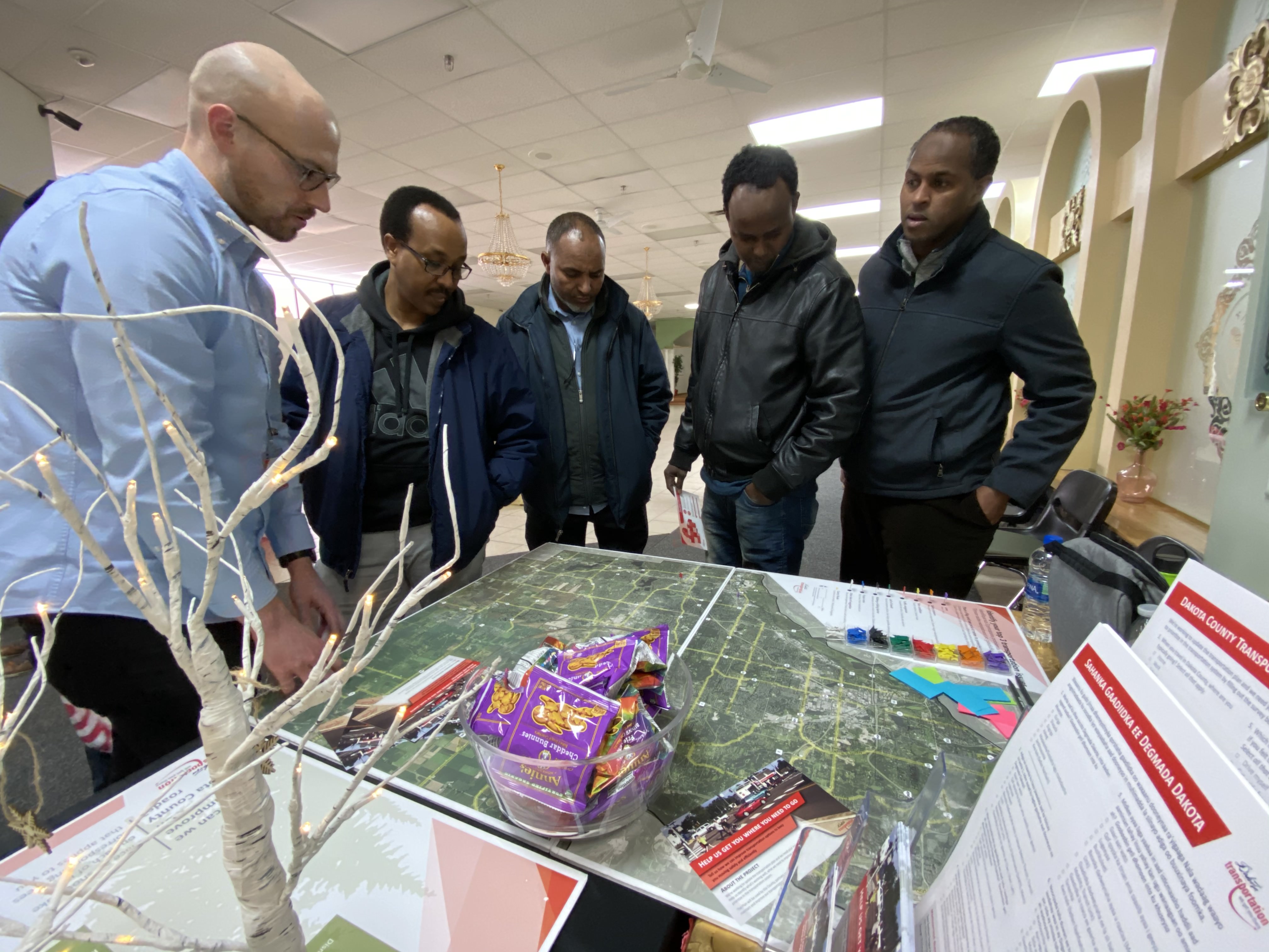 Residents gathered around a transportation map at a community session