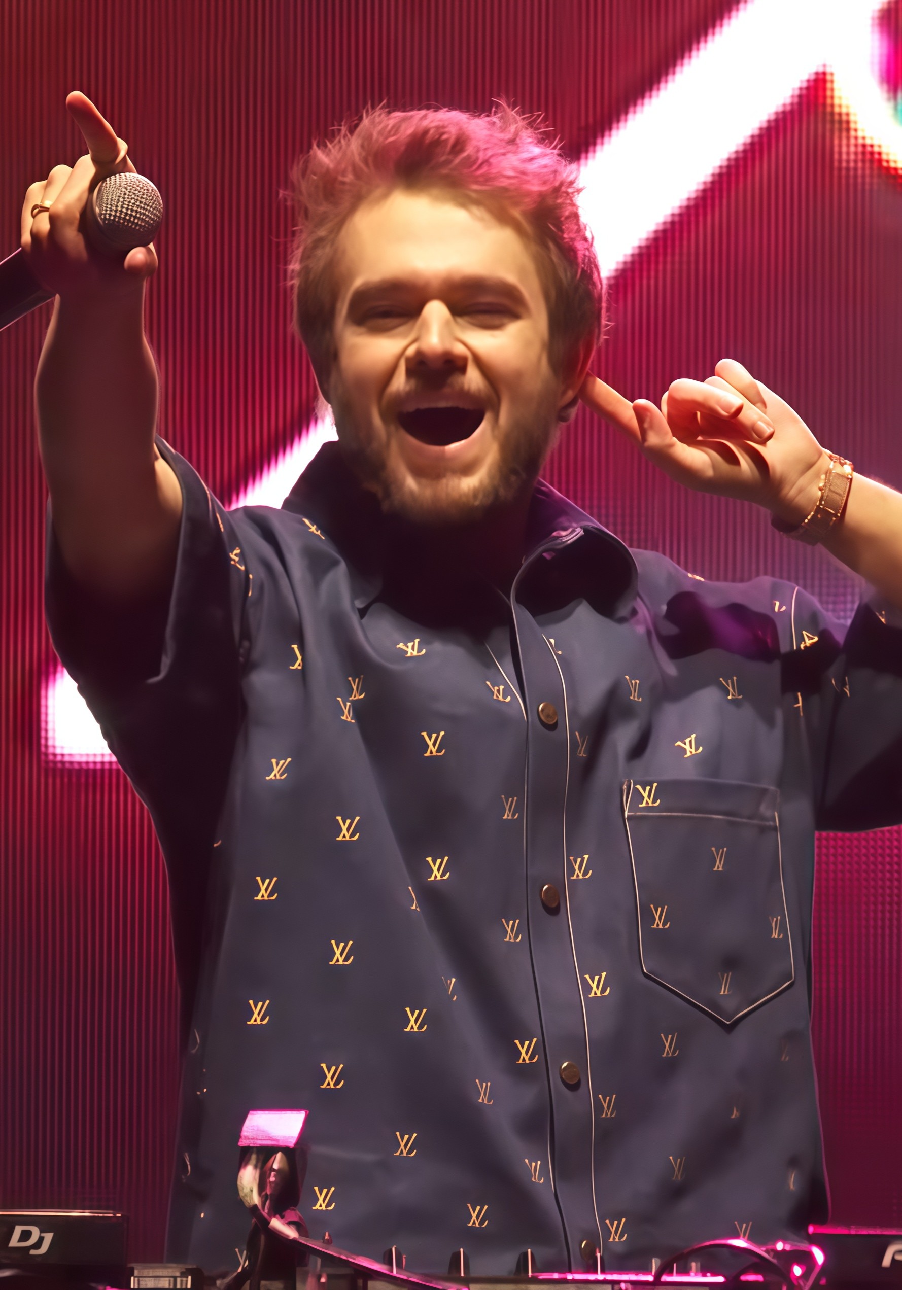 Zedd performing beneath vivid red stage lighting at the AT&T Block Party in 2024
