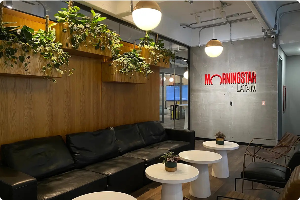 Morningstar LATAM reception space with plants, seating and the company name on a concrete wall