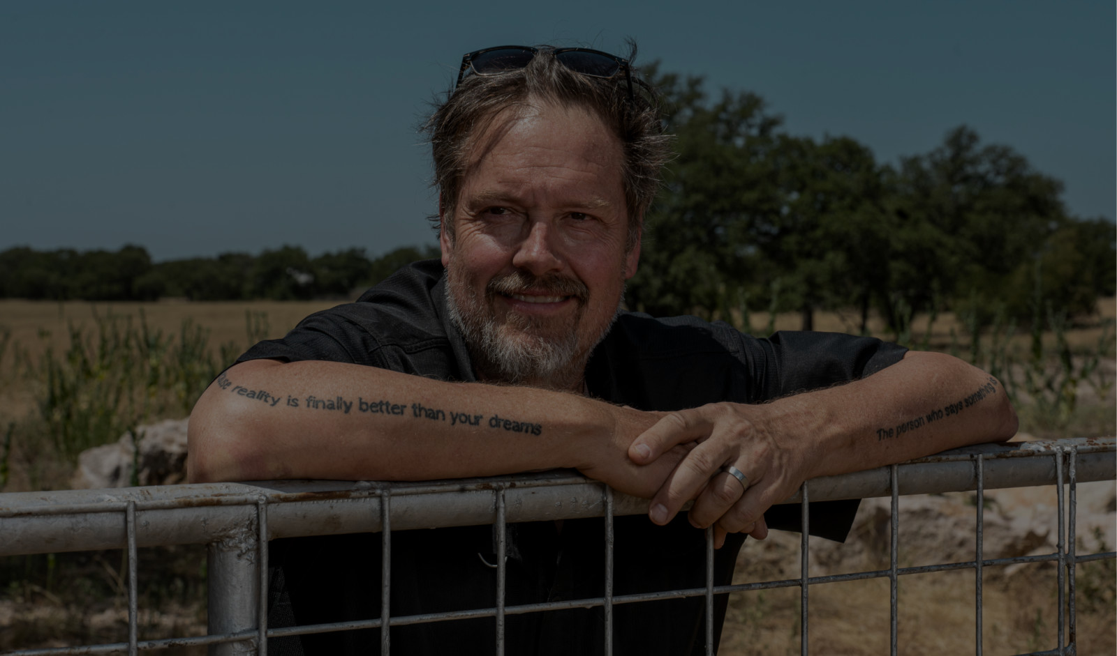 ZenBusiness co-founder and CEO Ross Buhrdorf leaning on a ranch gate