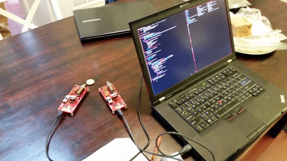 Early ZeroTier development setup with laptop and two red circuit boards