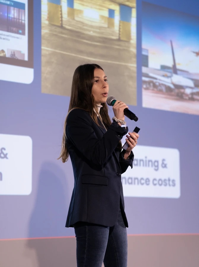 A speaker presenting with a microphone at Zero Pitch Day 2025