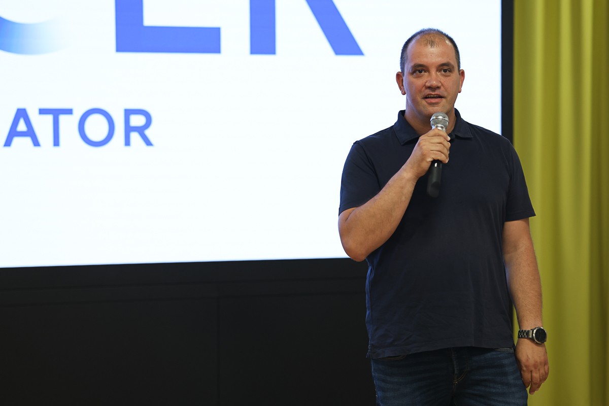 Speaker holding a microphone at ZICER’s 2026 accelerator launch