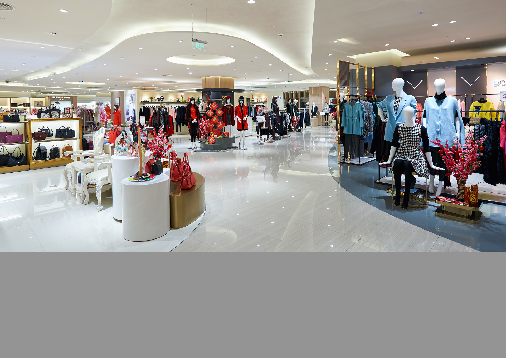 Clothing displays and mannequins across a department-store floor