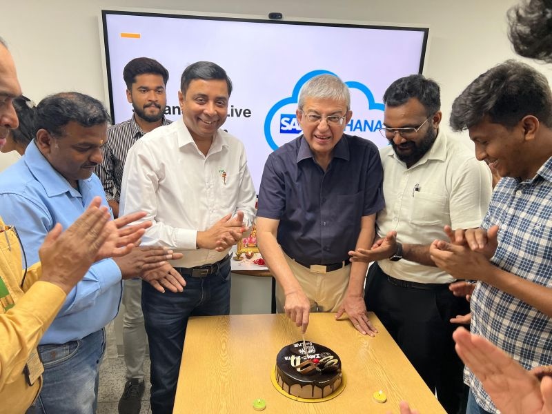 Participants cutting a cake at INDIC’s SAP S/4HANA implementation celebration