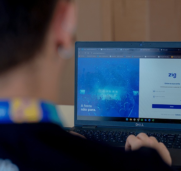 An operator at a laptop showing the Zig management login