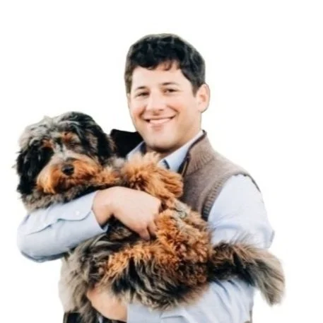 Zintro CEO Tyler Lewtan holding a dog in his official team portrait