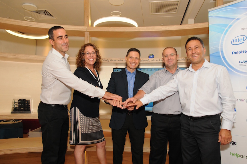 Five participants join hands at CDI’s August 2015 opening in Beersheba; Ziv Ofek is second from the right.