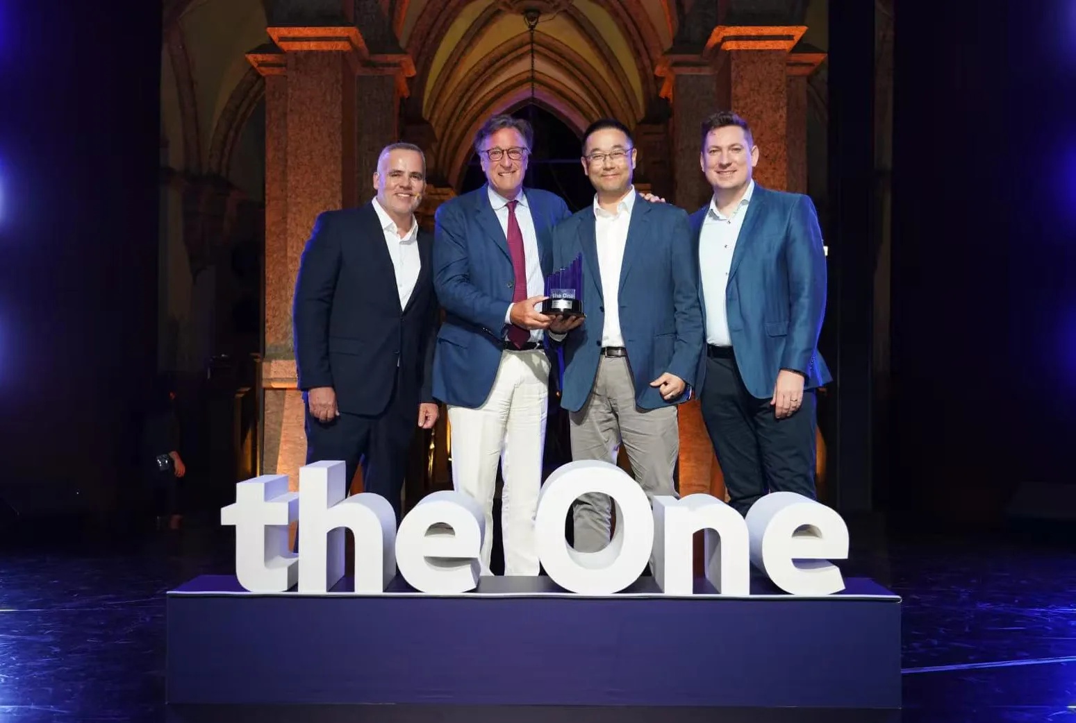 Ziyu Shen, second from right, with executives and a trophy at Volkswagen Brazil’s The One 2026 event