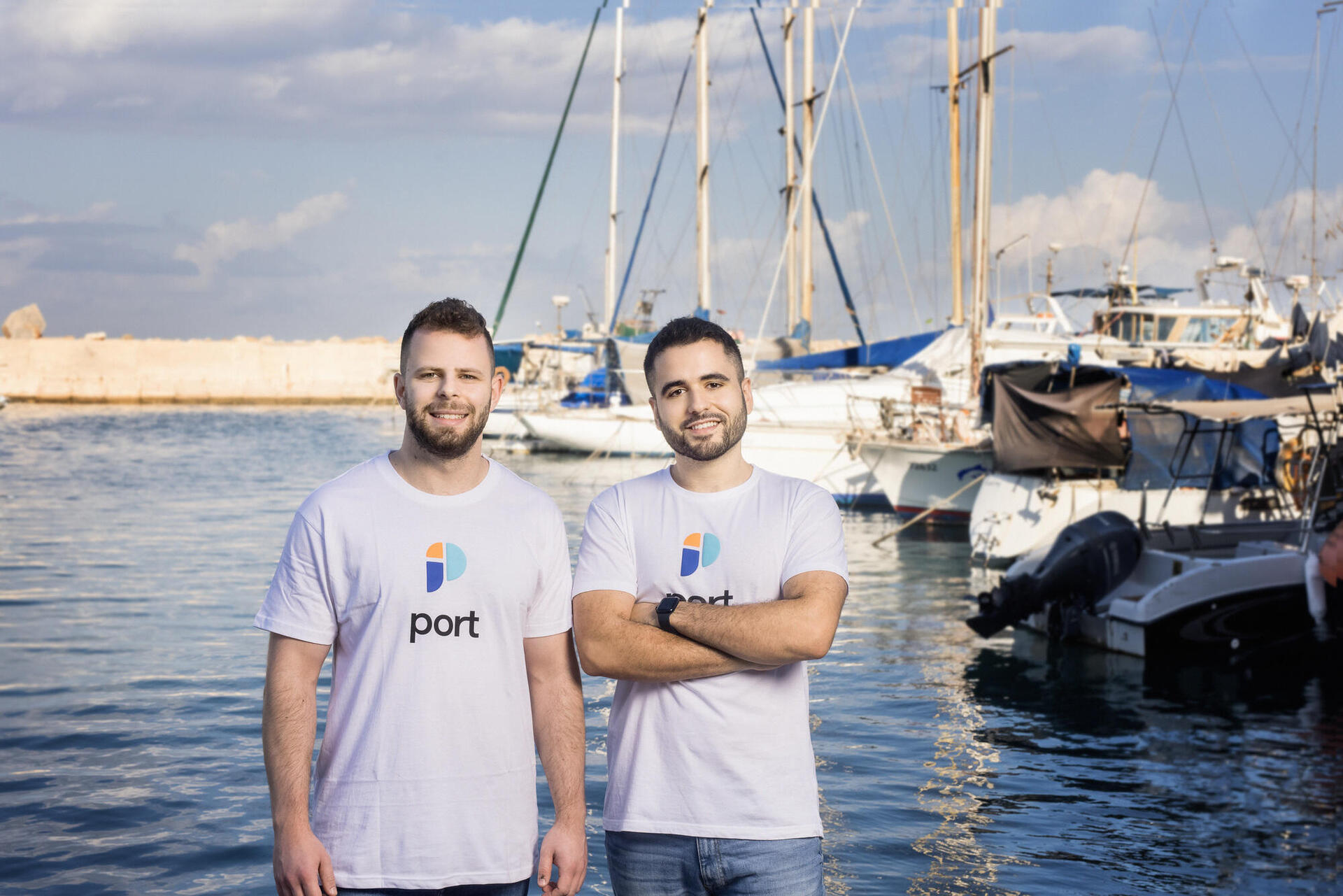 Port co-founders Yonatan Boguslavski, left, and Zohar Einy, right, standing beside sailboats