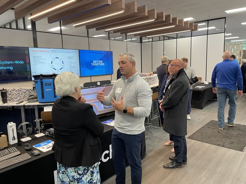 Visitors explore technology demonstrations at the Zones Innovation Center opening in Carol Stream.