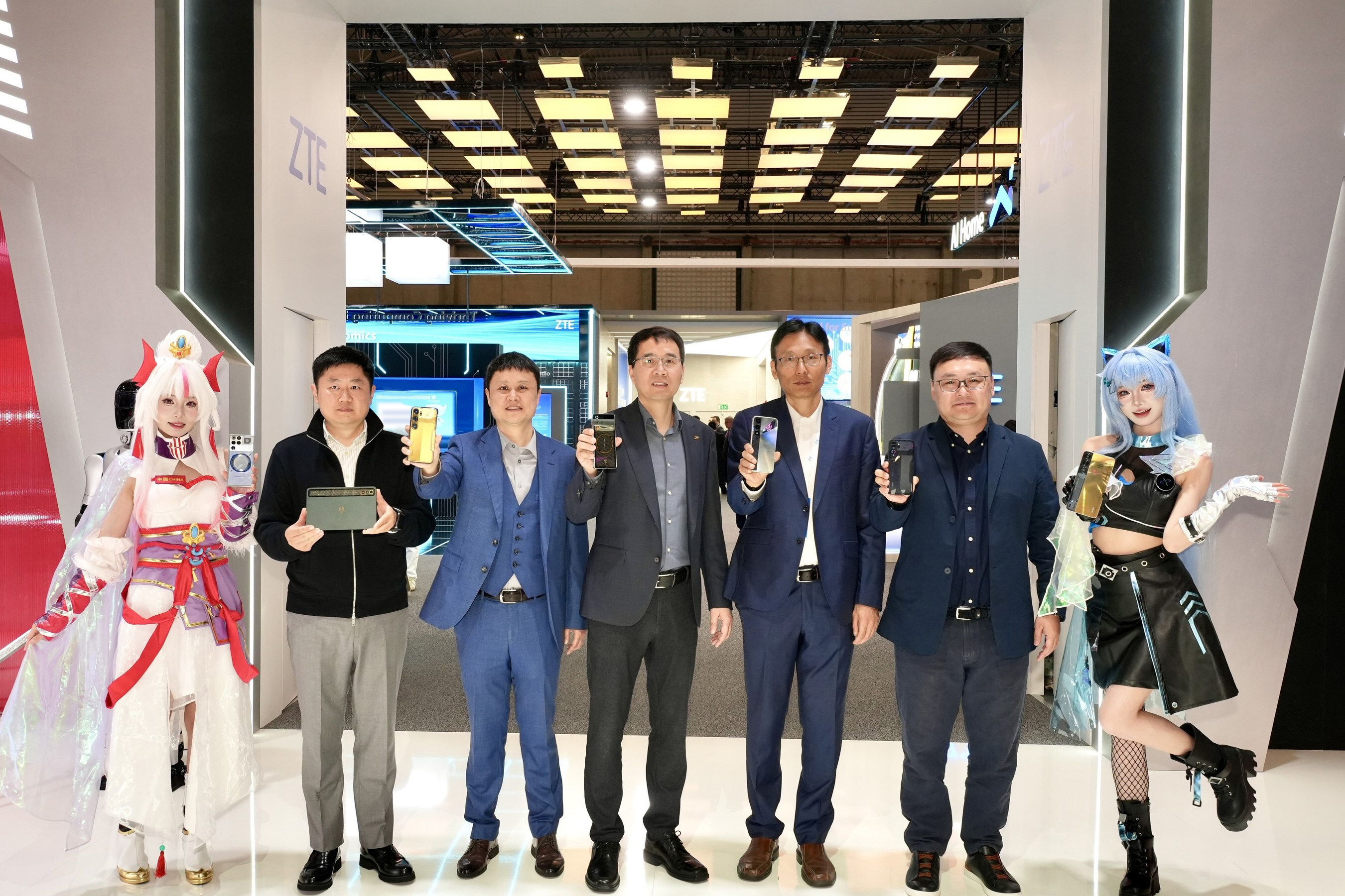 ZTE executives holding new mobile devices, flanked by costumed presenters at MWC Barcelona 2026